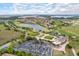 High angle aerial view with lush golf course and the lake nearby, showcasing an expansive community at 10533 Belfry Cir, Orlando, FL 32832