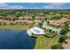 Aerial view of the community pool and landscaping near a tranquil pond in a lush setting at 10533 Belfry Cir, Orlando, FL 32832