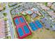 Aerial view of community amenities featuring tennis and basketball courts and a pool with splashpad surrounded by residences at 10533 Belfry Cir, Orlando, FL 32832