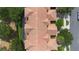 Bird's-eye view of condo rooftops with screened lanais surrounded by trees at 10533 Belfry Cir, Orlando, FL 32832