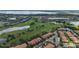 Scenic aerial view showcasing the community's lush golf course, pond, and well-maintained residences at 10533 Belfry Cir, Orlando, FL 32832