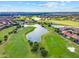 Panoramic aerial view of a golf course community with multiple lakes and lush greenery at 10533 Belfry Cir, Orlando, FL 32832