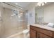 Bathroom featuring a walk-in shower, vanity with granite countertop, and stylish fixtures at 10533 Belfry Cir, Orlando, FL 32832