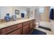 Bathroom vanity features wood cabinets, granite counters, and modern fixtures at 10533 Belfry Cir, Orlando, FL 32832