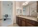 Spacious bathroom with granite countertops, wood cabinets, and open doorway to office at 10533 Belfry Cir, Orlando, FL 32832
