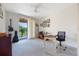 Spacious bedroom with natural light, a desk, and access to a balcony, providing a relaxing and versatile living space at 10533 Belfry Cir, Orlando, FL 32832