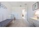 Bright bedroom features neutral carpet, white walls, a chair, and a charming crib at 10533 Belfry Cir, Orlando, FL 32832