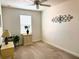 Bedroom with neutral carpet, window with blinds, and accent pieces adorning the wall at 10533 Belfry Cir, Orlando, FL 32832