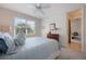 Inviting bedroom with comfortable bed, neutral decor, and an open doorway to an office at 10533 Belfry Cir, Orlando, FL 32832