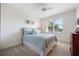 Bright bedroom with a ceiling fan, plush carpet, and a comfortable bed at 10533 Belfry Cir, Orlando, FL 32832