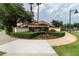 Well-maintained entrance to Curzon Place featuring lush landscaping and elegant signage at 10533 Belfry Cir, Orlando, FL 32832