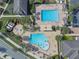 Aerial view of a community pool featuring a splash pad, swimming areas, cabanas, and seating for Gathering fun at 10533 Belfry Cir, Orlando, FL 32832