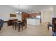 Open-concept dining area flowing into the kitchen, featuring a stylish chandelier and modern decor at 10533 Belfry Cir, Orlando, FL 32832