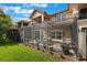 Exterior view of the screened-in patio, showcasing the beautiful backyard and the home's elegant architectural details at 10533 Belfry Cir, Orlando, FL 32832