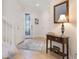 Inviting foyer with neutral-toned tile flooring, entry table and stairway to the second floor at 10533 Belfry Cir, Orlando, FL 32832