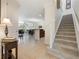 Bright open-concept foyer with stairs leading to second floor and views of living room and dining area at 10533 Belfry Cir, Orlando, FL 32832