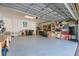 Spacious garage with epoxy flooring, workshop area, and ample storage solutions at 10533 Belfry Cir, Orlando, FL 32832