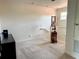 Hallway with neutral carpet features a staircase and a window for natural light at 10533 Belfry Cir, Orlando, FL 32832