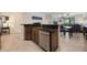 Kitchen island with stainless steel dishwasher and granite countertop overlooks the breakfast nook at 10533 Belfry Cir, Orlando, FL 32832