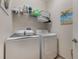 Functional laundry room features a washer, dryer, overhead shelving, and storage at 10533 Belfry Cir, Orlando, FL 32832