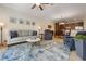 Relaxing living room features a comfortable sofa, recliner and a ceiling fan with access to the kitchen and dining areas at 10533 Belfry Cir, Orlando, FL 32832