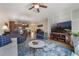 Inviting living room featuring comfortable seating, a ceiling fan, and open flow to dining and kitchen at 10533 Belfry Cir, Orlando, FL 32832
