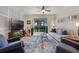 Comfortable living room with a large TV, a ceiling fan, and sliding doors leading to the outdoors at 10533 Belfry Cir, Orlando, FL 32832