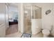Main bathroom with glass enclosed shower, toilet, and entry to main bedroom at 10533 Belfry Cir, Orlando, FL 32832