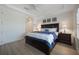 Main bedroom featuring a tray ceiling, light wood floors, and matching furniture at 10533 Belfry Cir, Orlando, FL 32832
