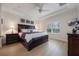 Spacious main bedroom featuring a tray ceiling, light wood floors, and bright window at 10533 Belfry Cir, Orlando, FL 32832