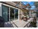 Covered patio features brick pavers, stone columns and sliding glass door to home's interior at 10533 Belfry Cir, Orlando, FL 32832