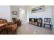 Inviting sitting room featuring comfortable armchairs, a storage unit, and a relaxing ambiance for casual gatherings at 10533 Belfry Cir, Orlando, FL 32832