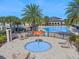 Aerial view of splash pad and community pool featuring water features, lounge chairs, and palm trees at 10533 Belfry Cir, Orlando, FL 32832