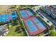 Aerial shot of well-maintained tennis and basketball courts in a vibrant residential community at 10533 Belfry Cir, Orlando, FL 32832