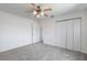 This carpeted bedroom features a ceiling fan and a closet with ample storage space at 10980 Sw 62Nd Ave, Ocala, FL 34476