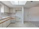 Efficient kitchen with white cabinets, tiled floors, and an adjacent area at 10980 Sw 62Nd Ave, Ocala, FL 34476