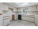Functional kitchen features white cabinets, matching appliances, and tiled backsplash at 10980 Sw 62Nd Ave, Ocala, FL 34476