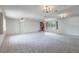 Spacious living room with plush carpeting, brick fireplace, ceiling fans, and bright natural light at 10980 Sw 62Nd Ave, Ocala, FL 34476