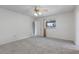 Cozy main bedroom with plush carpet, ceiling fan, and bright window at 10980 Sw 62Nd Ave, Ocala, FL 34476