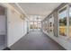 Enclosed sunroom featuring multiple windows, carpet and a ceiling fan for comfortable relaxation at 10980 Sw 62Nd Ave, Ocala, FL 34476