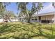 Spacious backyard with grassy area, play set, and fire pit at 1101 Mizell Rd, Leesburg, FL 34748
