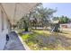 Home's backyard featuring a playground, grass, and mature shade trees at 1101 Mizell Rd, Leesburg, FL 34748
