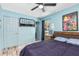Light blue bedroom with closet, ceiling fan, bed, and Mario poster at 1101 Mizell Rd, Leesburg, FL 34748