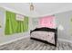 Cozy bedroom featuring pastel walls and modern flooring at 1101 Mizell Rd, Leesburg, FL 34748