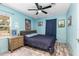 Comfortable bedroom featuring blue walls, wood-look floors, and ceiling fan at 1101 Mizell Rd, Leesburg, FL 34748