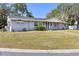 Lovely home featuring a green front lawn, sidewalk, and mature trees at 1101 Mizell Rd, Leesburg, FL 34748