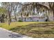 Beautiful home with a lush green lawn and trees covered in Spanish moss at 1101 Mizell Rd, Leesburg, FL 34748