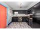 Well-lit kitchen with dark cabinets, subway tile, and modern flooring at 1101 Mizell Rd, Leesburg, FL 34748