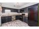 Stylish kitchen featuring black cabinets, subway tile backsplash, and stainless steel appliances at 1101 Mizell Rd, Leesburg, FL 34748