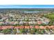 An aerial view shows neighborhood homes with lush landscaping near a lake community at 11556 Via Lucerna Cir, Windermere, FL 34786